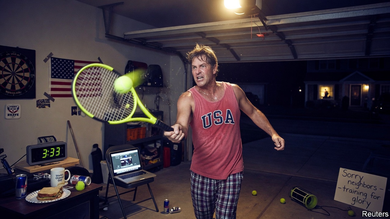 A tennis stadium lit up at night with a scoreboard showing a very late finish time and fans holding tiny American flags.