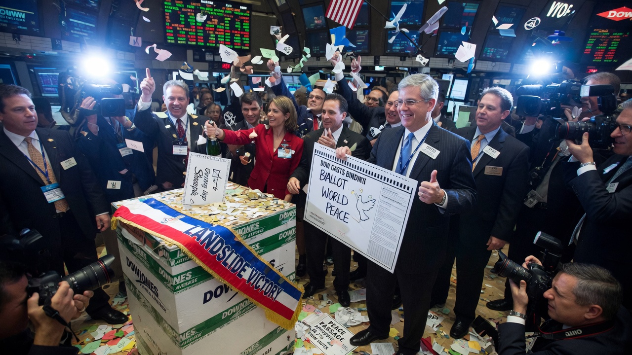 Ron Rugundy points triumphantly at a stock ticker while a trader beside him checks a blue mood ring.